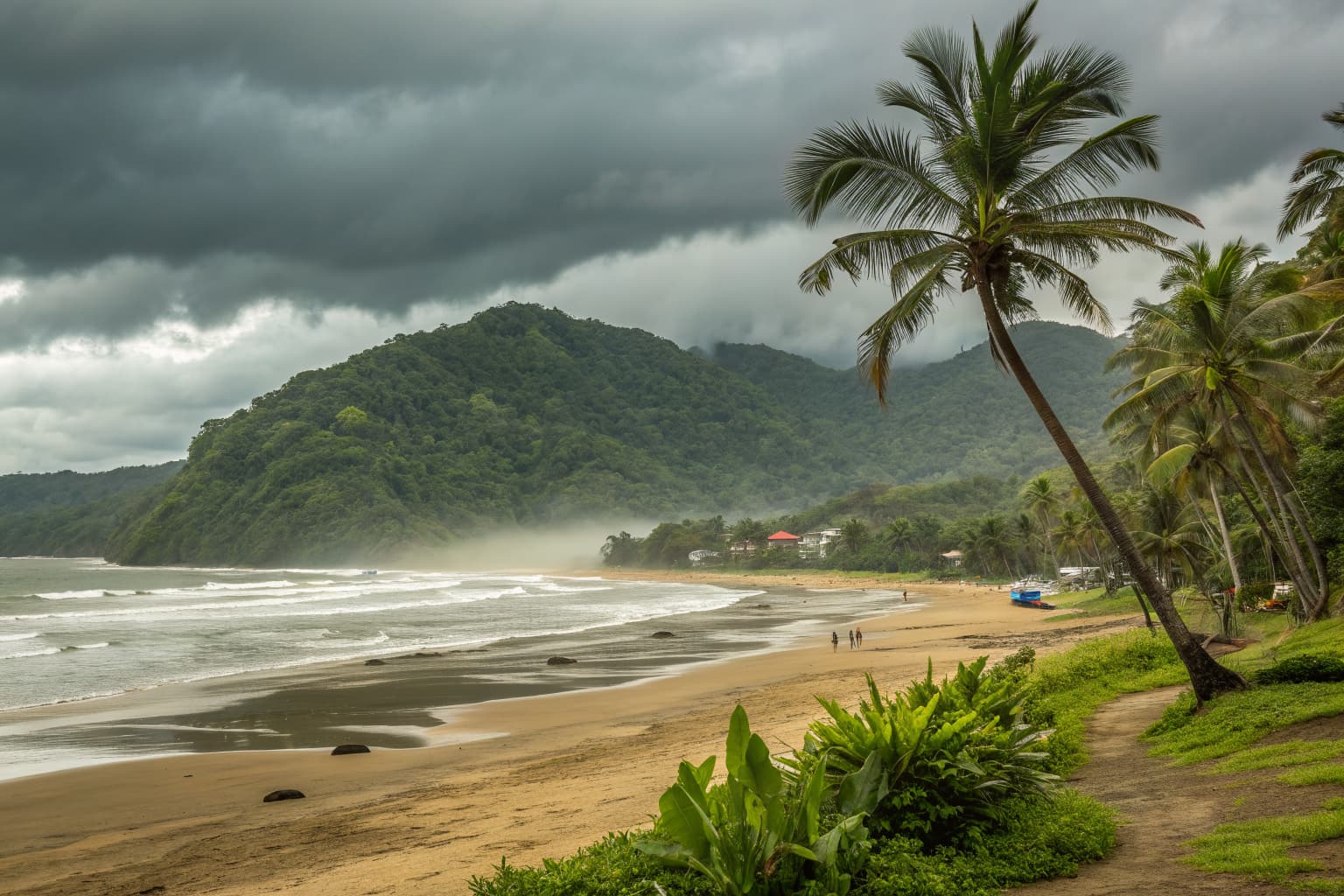 Jaco Beach Costa Rica in October — heavy grey rain clouds over deep green jungle hills and a golden sand shoreline along the Pacific coast