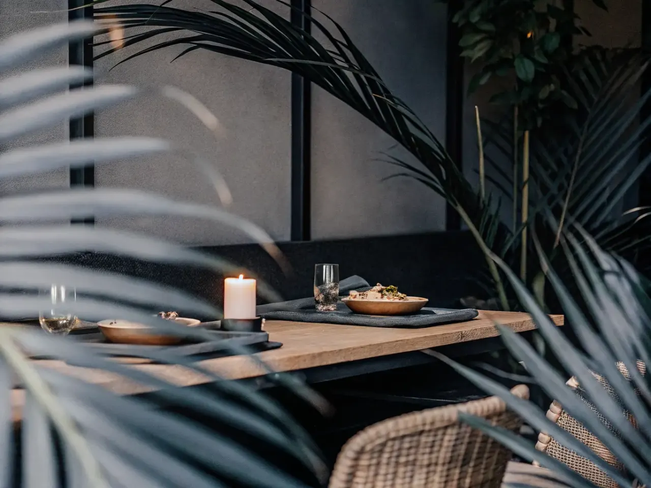 Private dining table with candles and tropical plants for a VIP tour experience