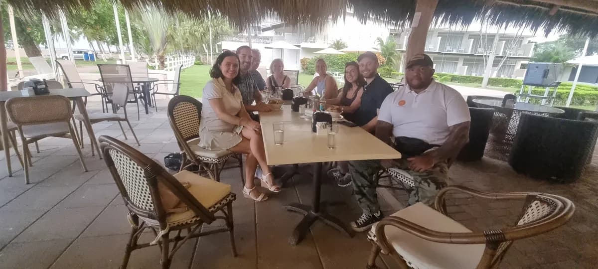 Community group gathering at an open-air beachside restaurant in Jaco