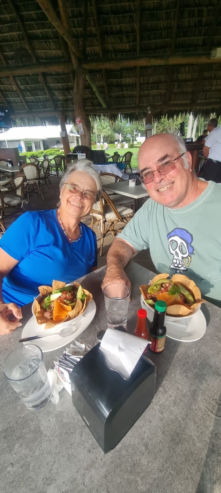Couple enjoying local Costa Rican dishes at an open-air palapa restaurant on the food tour