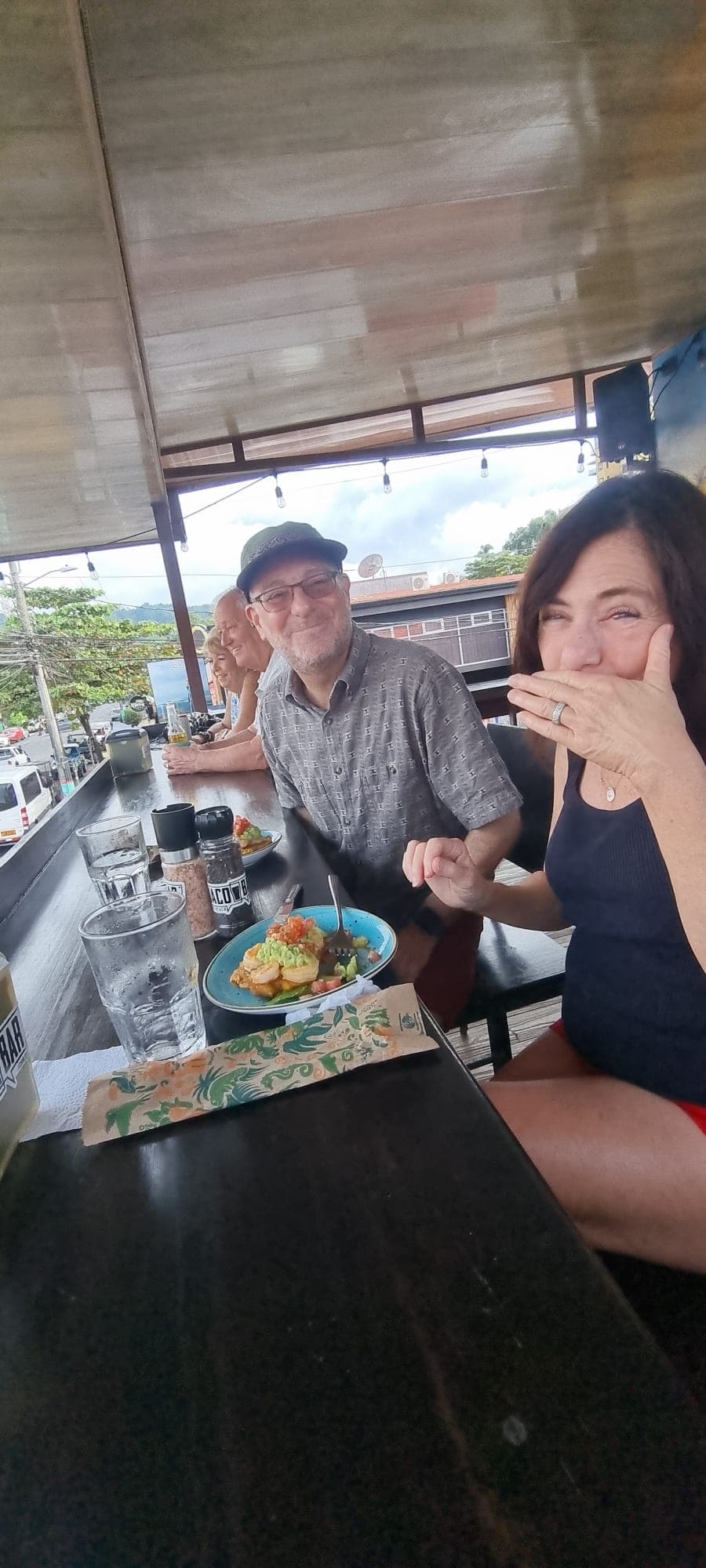 Couple laughing together over a plate of Costa Rican cuisine at a Jaco restaurant