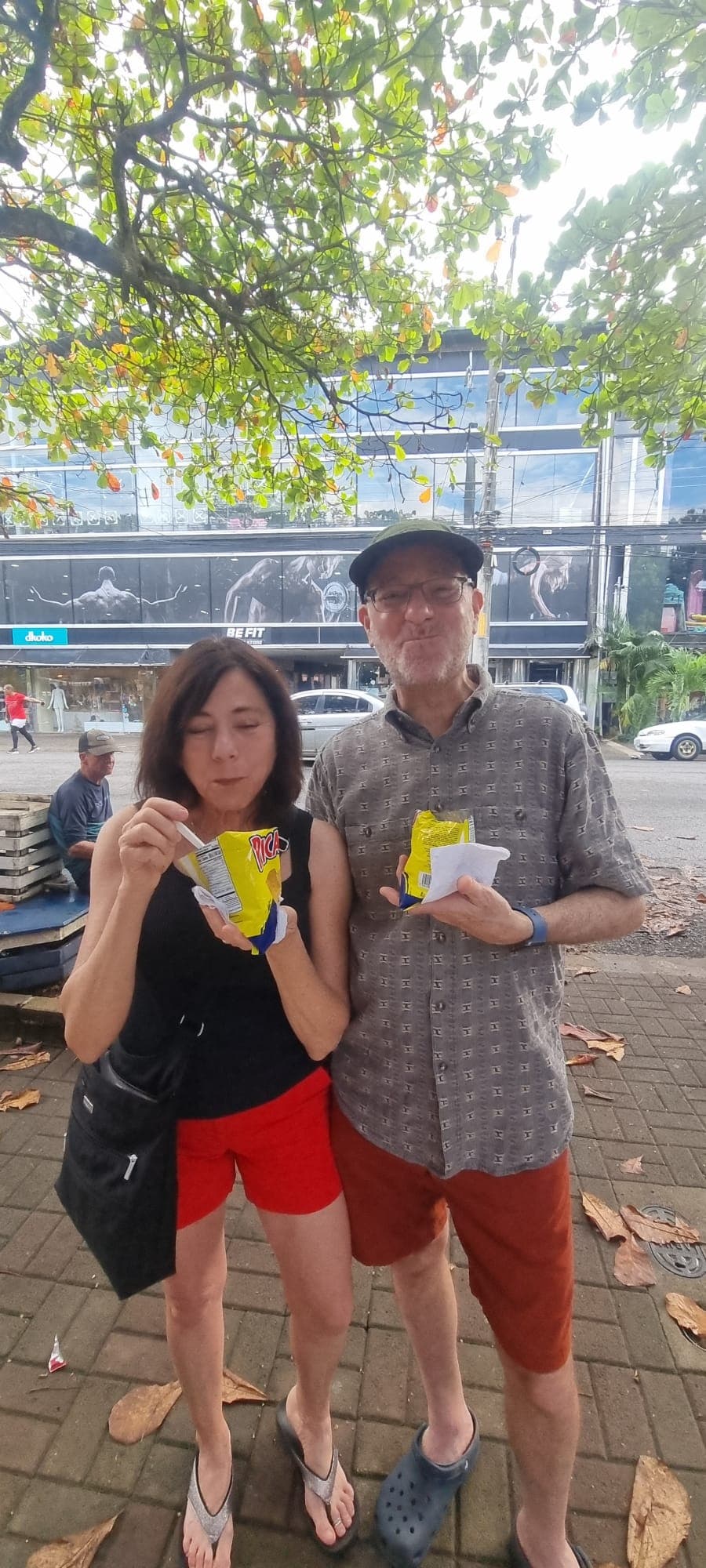 Couple sampling street snacks during the walking portion of the Taste of Jaco food tour