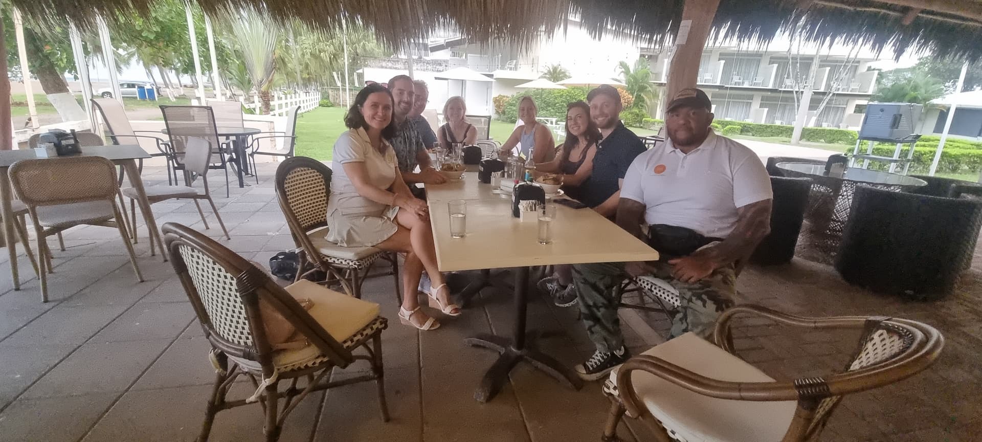 Large group enjoying a Taste of Jaco food tour at an open-air beachfront restaurant