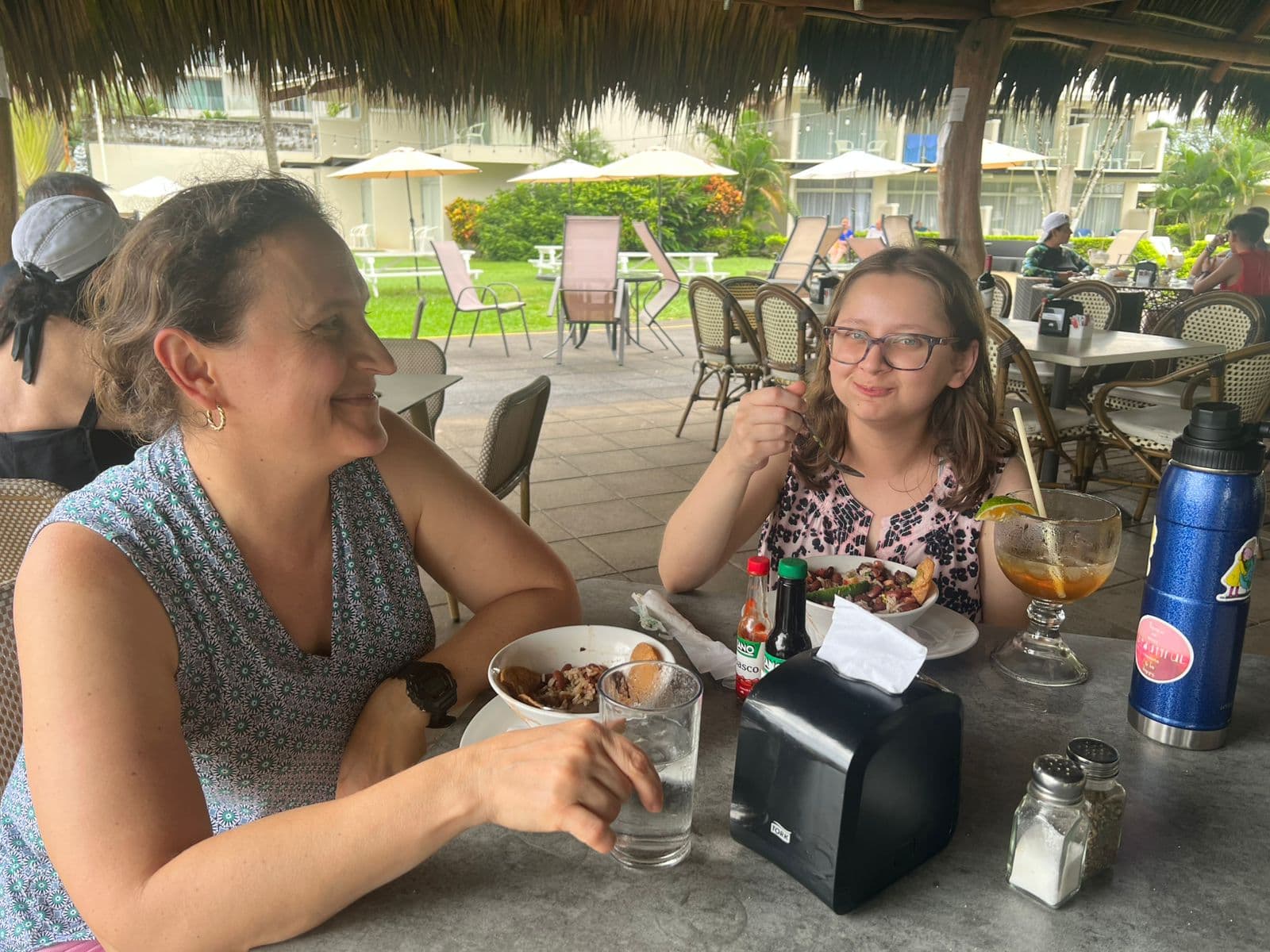 Mother and daughter enjoying the Taste of Jaco food tour at a beachfront restaurant